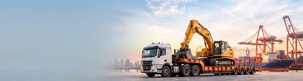 Flatbed truck transporting an excavator at a port
